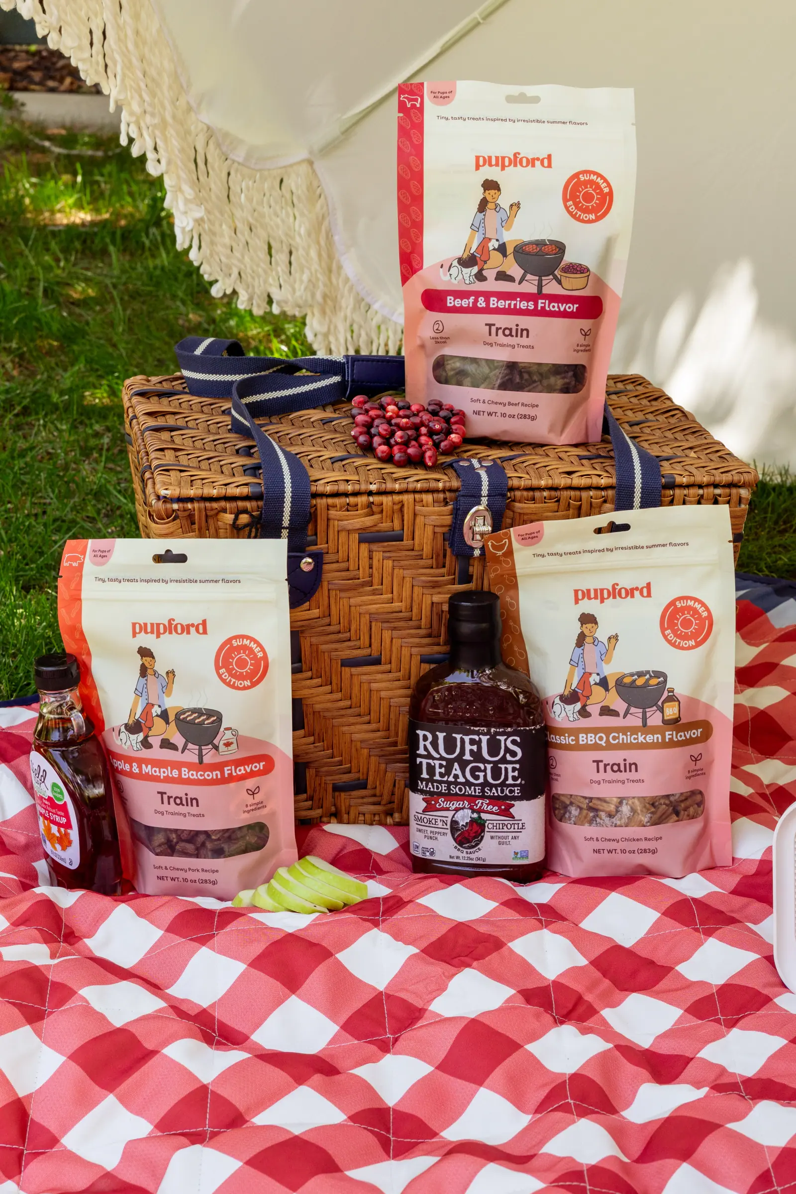 The Pupford range arranged with a picnic basket on a red gingham blanket