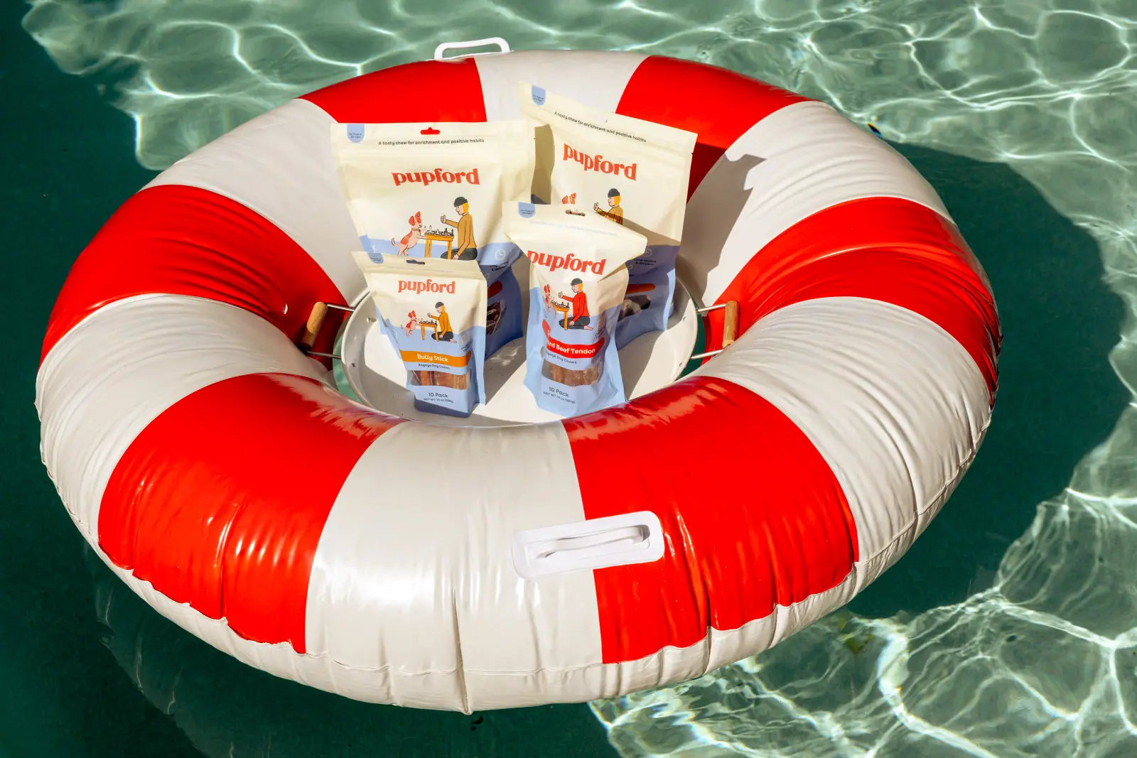 Pupford bags sitting inside a red and white pool ring floating on water
