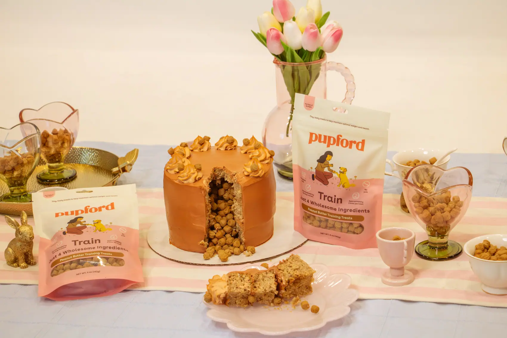 Styled pastel table with a dog cake, tulips and Pupford treats