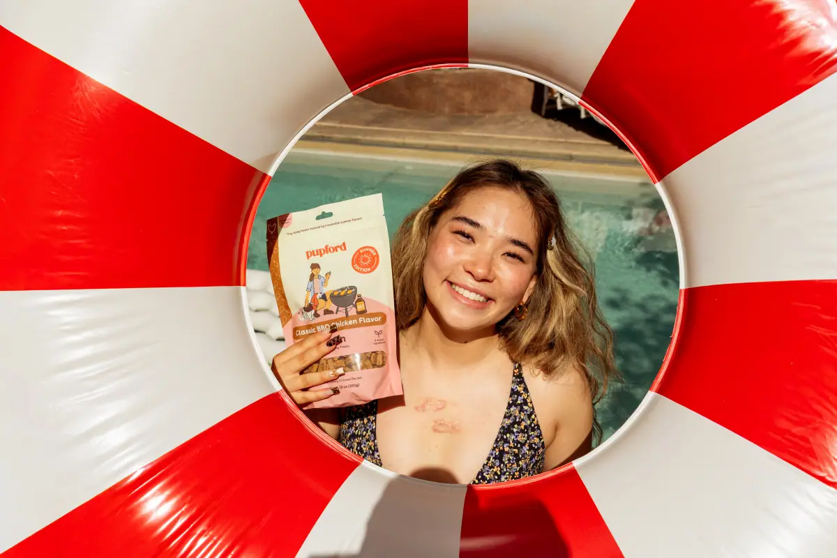 Woman framed inside a red and white pool ring